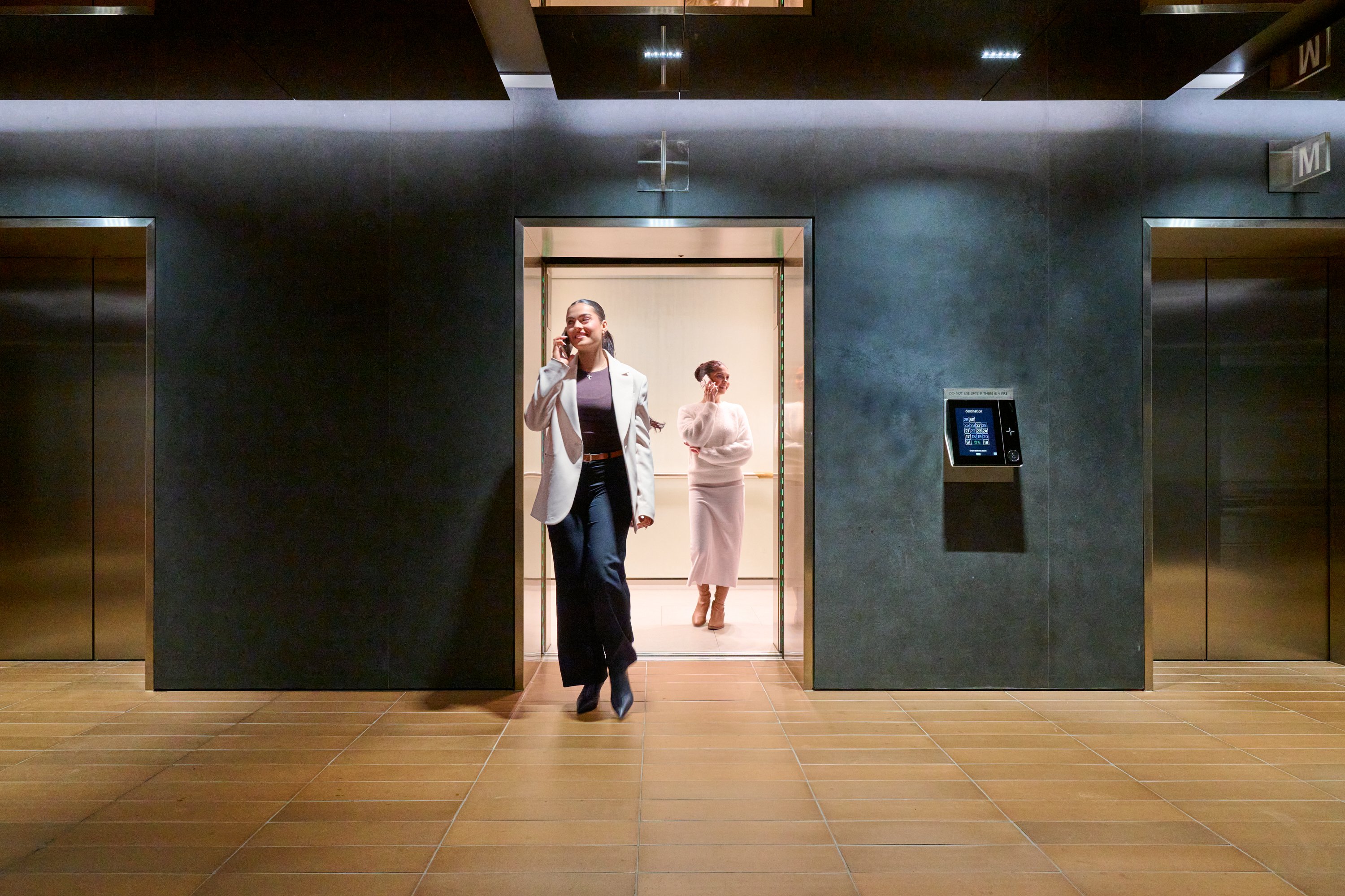 IFM_Investors_Tennant_Experience_Intuitive technology_Woman_walks_out_of_lift.jpg